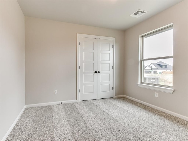 carpeted spare room with plenty of natural light