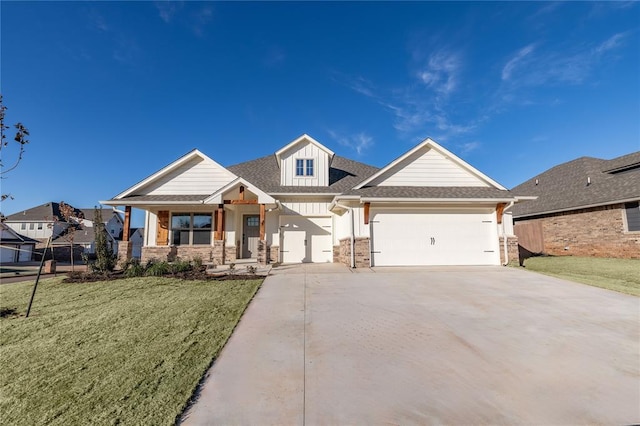 craftsman inspired home featuring a garage and a front lawn