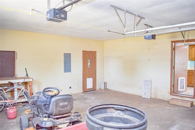 garage featuring electric panel and a garage door opener