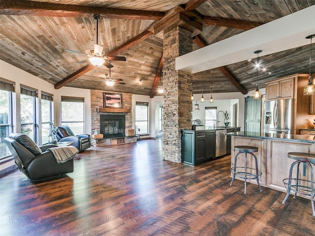 living room with dark hardwood / wood-style flooring, wood ceiling, ceiling fan, beam ceiling, and high vaulted ceiling