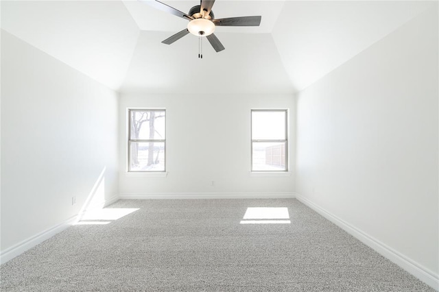 unfurnished room featuring a ceiling fan, carpet, vaulted ceiling, and baseboards