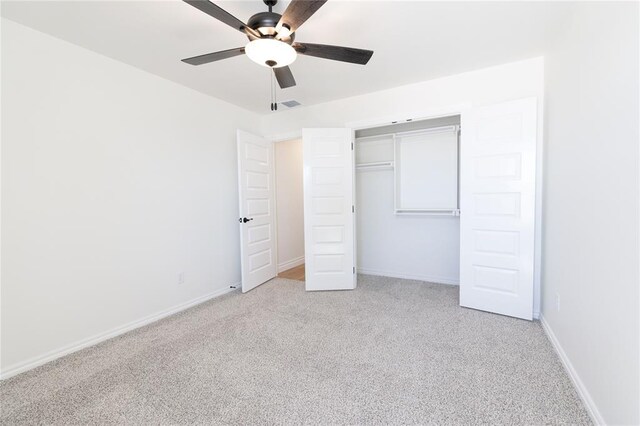 unfurnished bedroom with visible vents, baseboards, a ceiling fan, light colored carpet, and a closet