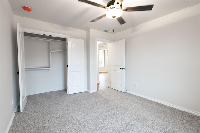 unfurnished bedroom featuring light colored carpet, a closet, and ceiling fan