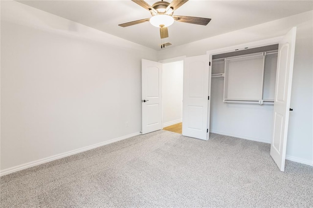 unfurnished bedroom with light colored carpet, ceiling fan, and a closet