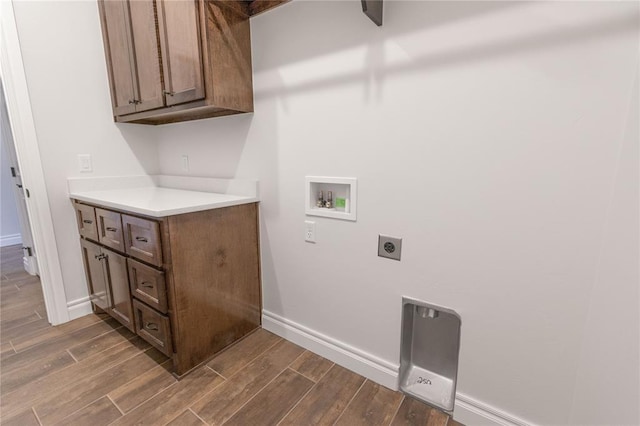 washroom featuring cabinets, hookup for an electric dryer, and hookup for a washing machine