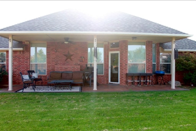 back of house with an outdoor hangout area, ceiling fan, a patio area, and a lawn