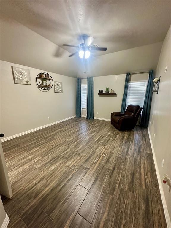 unfurnished living room featuring a wealth of natural light, dark hardwood / wood-style flooring, ceiling fan, and lofted ceiling