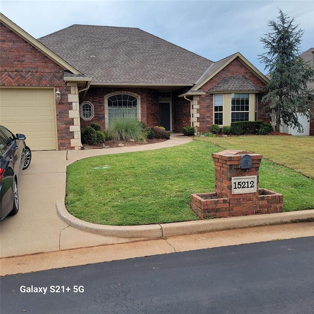 view of front of property with a front lawn and a garage