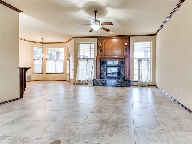 unfurnished living room featuring ceiling fan with notable chandelier, crown molding, and a high end fireplace