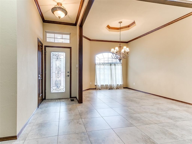 entryway with a wealth of natural light, a notable chandelier, and ornamental molding