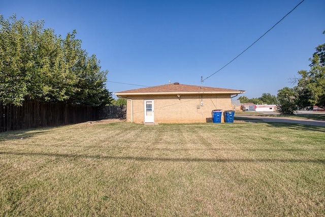 rear view of property featuring a yard