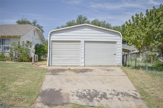 garage featuring a lawn and central AC