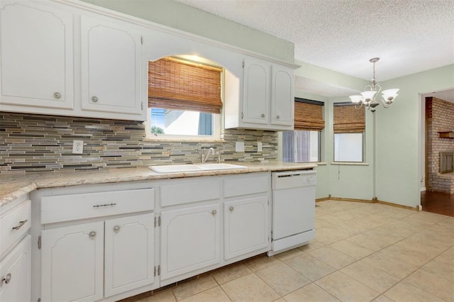 kitchen featuring dishwasher, sink, tasteful backsplash, decorative light fixtures, and white cabinetry