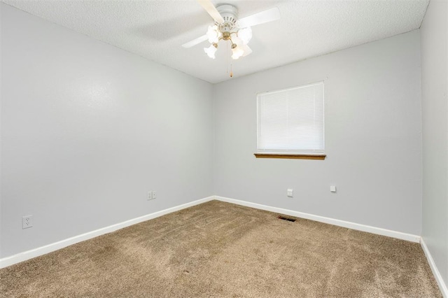 empty room featuring carpet flooring, a textured ceiling, and ceiling fan