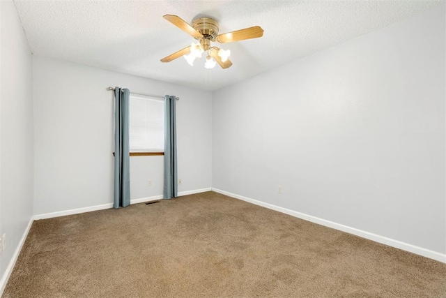 carpeted empty room featuring ceiling fan and a textured ceiling