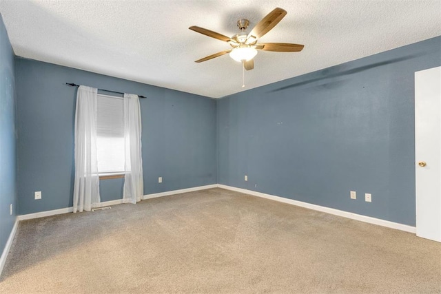 carpeted empty room featuring ceiling fan and a textured ceiling