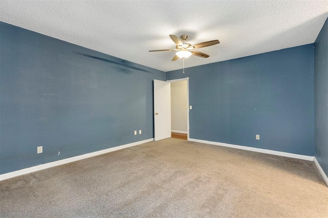 carpeted empty room with ceiling fan and a textured ceiling