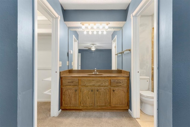 bathroom with ceiling fan, vanity, and toilet