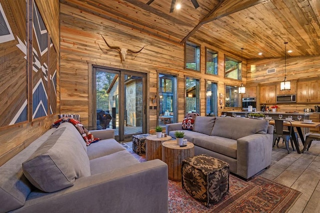 living room featuring wood walls, high vaulted ceiling, light hardwood / wood-style flooring, beamed ceiling, and wood ceiling