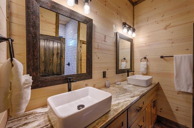 bathroom featuring vanity and wooden walls