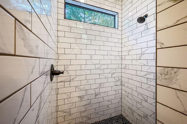 bathroom with a tile shower