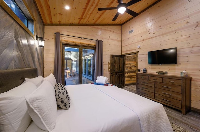 bedroom featuring hardwood / wood-style floors, wood walls, access to outside, ceiling fan, and wood ceiling