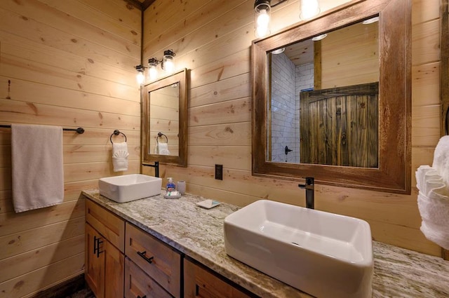 bathroom with vanity and wood walls