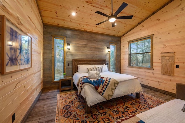 bedroom featuring dark hardwood / wood-style flooring, multiple windows, and vaulted ceiling