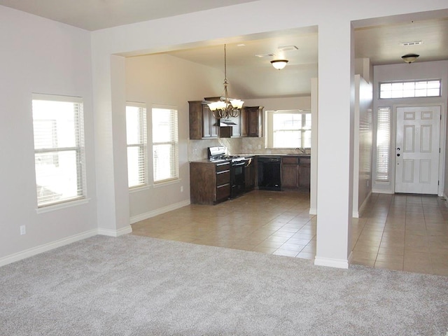 kitchen with black appliances, a healthy amount of sunlight, light colored carpet, and pendant lighting