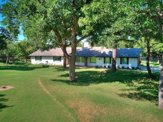 ranch-style home with a front lawn