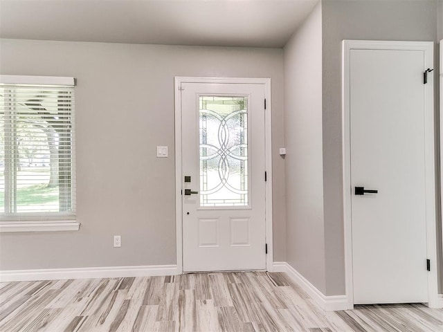 entrance foyer featuring light wood-type flooring and plenty of natural light