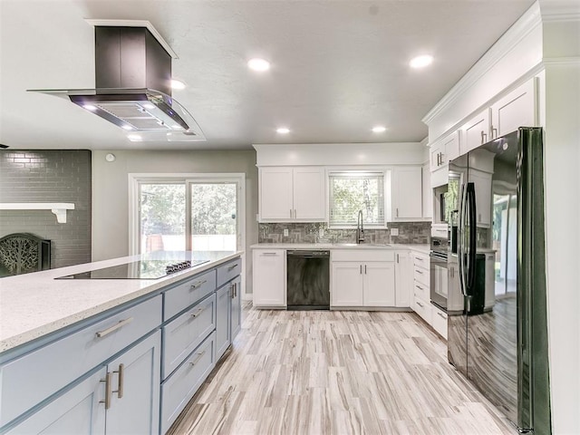 kitchen with black appliances, plenty of natural light, and white cabinetry