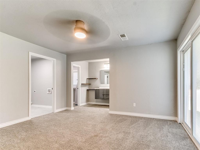 unfurnished living room featuring ceiling fan and light carpet