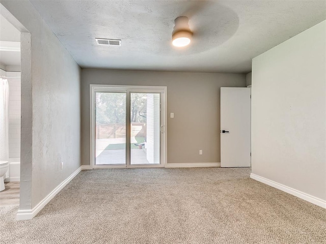 empty room featuring ceiling fan and light colored carpet