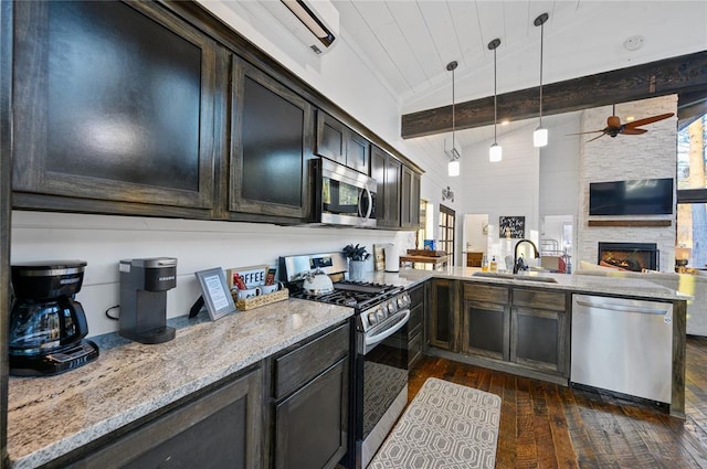 kitchen with sink, stainless steel appliances, vaulted ceiling with beams, decorative light fixtures, and dark brown cabinets