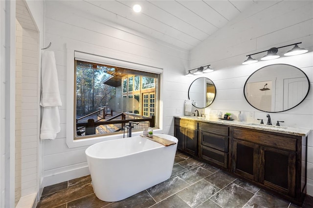 bathroom featuring a tub to relax in, vaulted ceiling, wooden walls, vanity, and wood ceiling