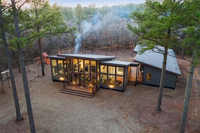 back of property with a sunroom