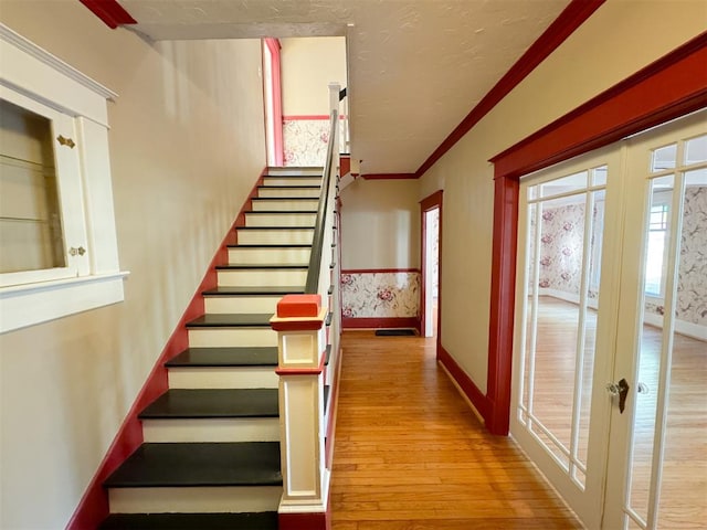 stairway featuring hardwood / wood-style flooring and ornamental molding