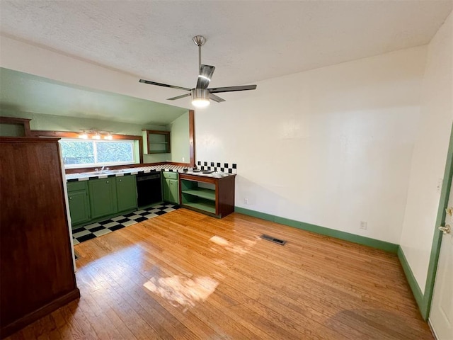 interior space featuring lofted ceiling, sink, ceiling fan, light wood-type flooring, and a textured ceiling