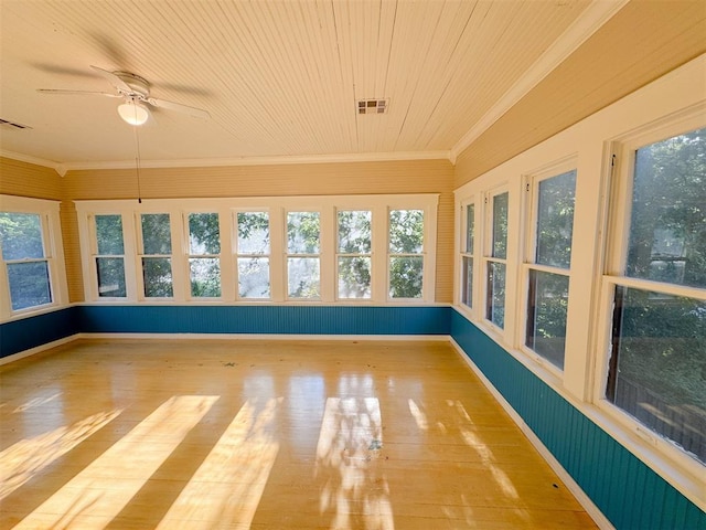 unfurnished sunroom with ceiling fan