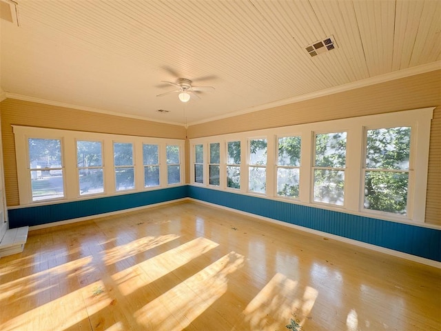 unfurnished sunroom with ceiling fan