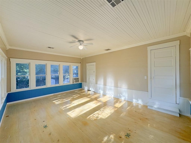 spare room with light wood-type flooring, cooling unit, ceiling fan, and ornamental molding