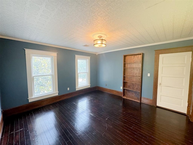 empty room featuring a textured ceiling, dark hardwood / wood-style floors, and crown molding