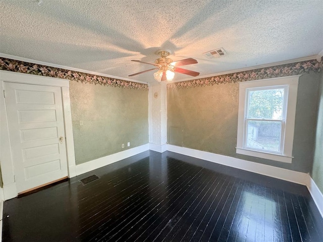 unfurnished room with dark hardwood / wood-style floors, ceiling fan, crown molding, and a textured ceiling