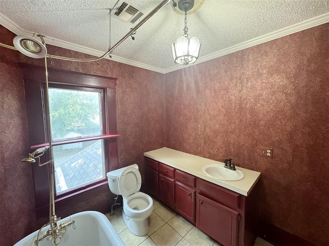 bathroom featuring tile patterned floors, a bathing tub, crown molding, toilet, and a textured ceiling