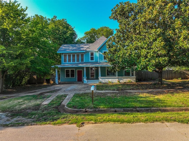 view of front facade with covered porch and a front yard