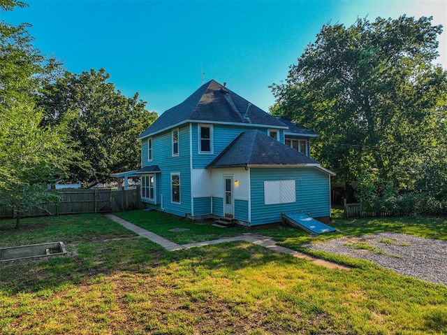 back of property featuring a yard