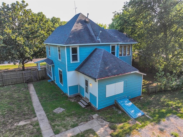 rear view of house with a yard