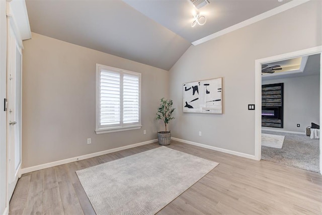 interior space featuring light hardwood / wood-style floors, vaulted ceiling, and ceiling fan