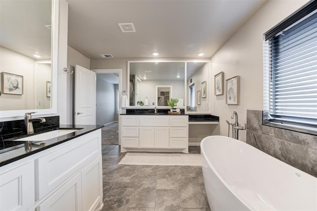 bathroom with vanity and a bathtub